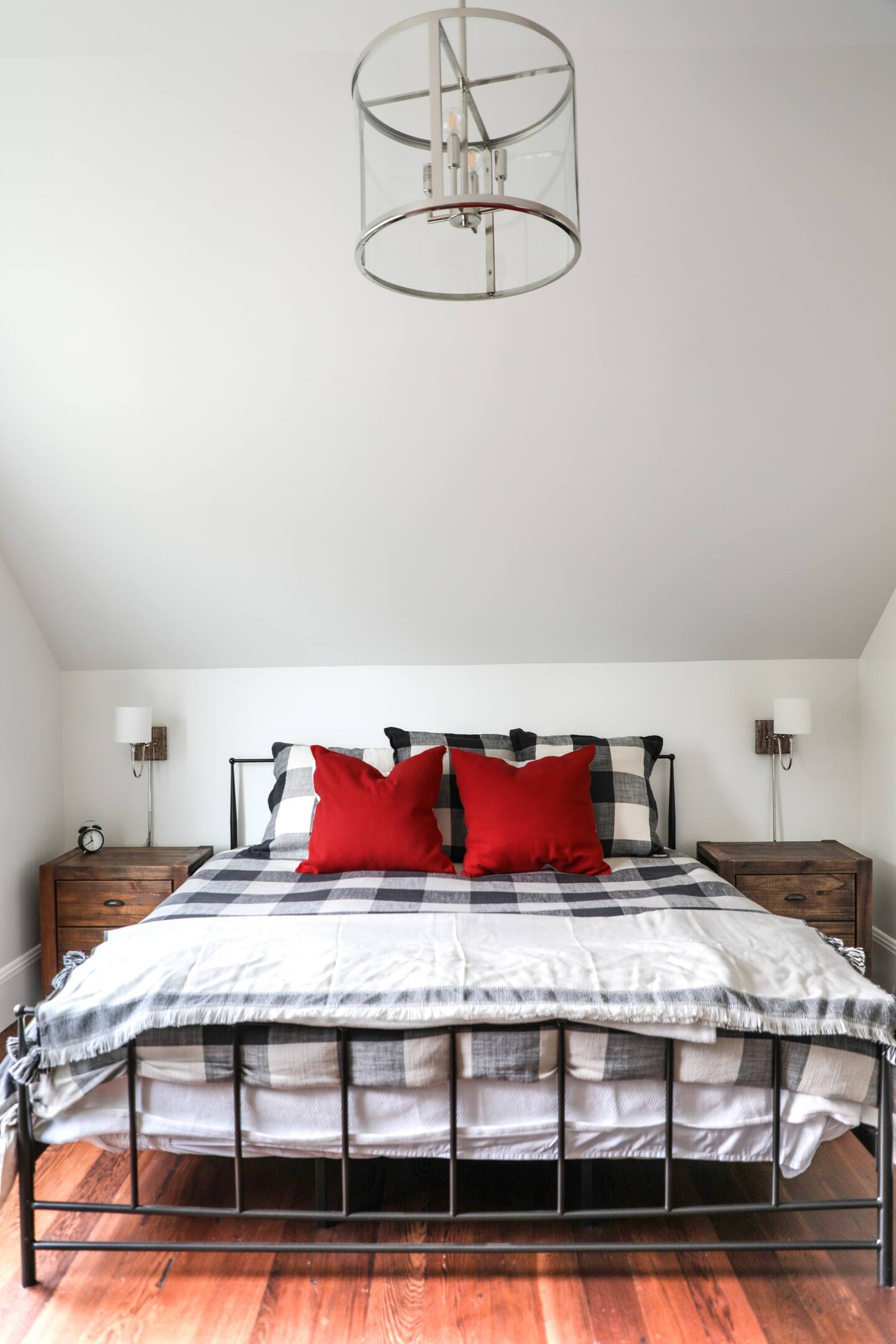 Primary bedroom has an en-suite bathroom, king-sized bed, writing desk, and Peloton bike.