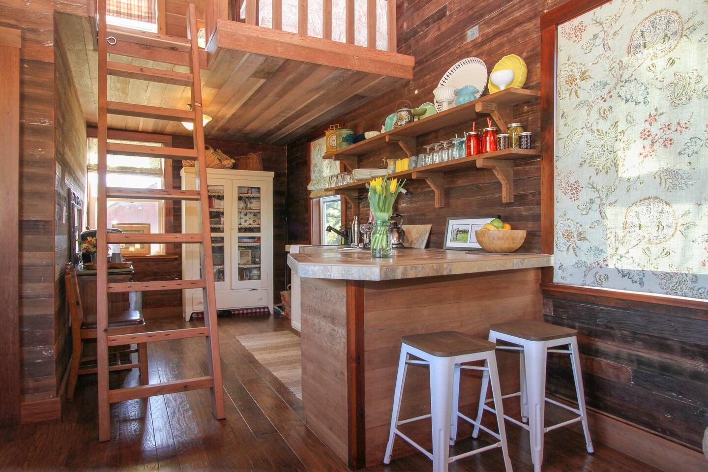 The Cabin's kitchenette and the ladder up to the sleeing loft.