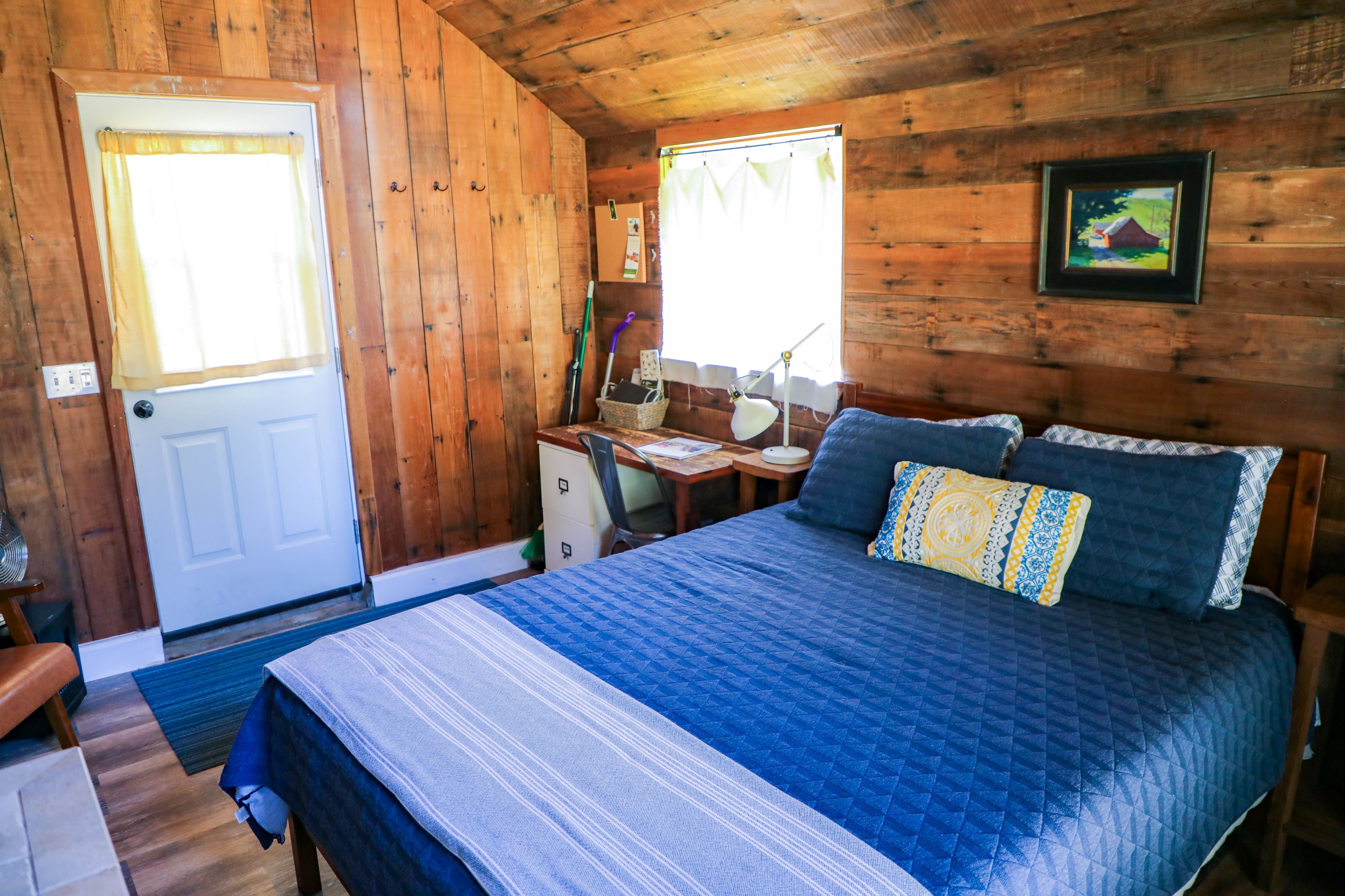 The Writer's Cottage is a studio with a queen-sized bed and writer's desk.