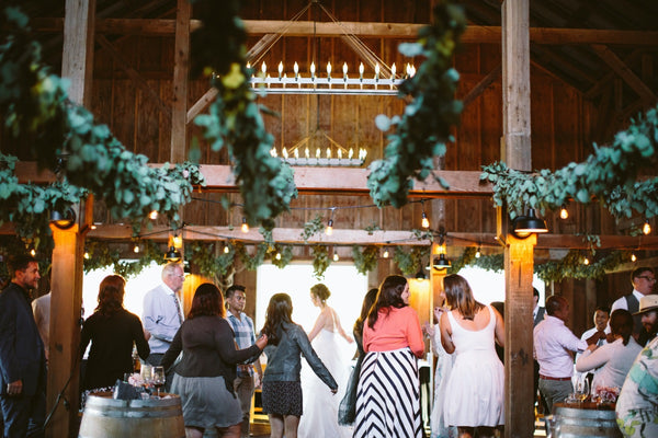 Wedding guests gathering at the historic barn