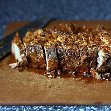Sliced beef brisket on a wooden cutting board