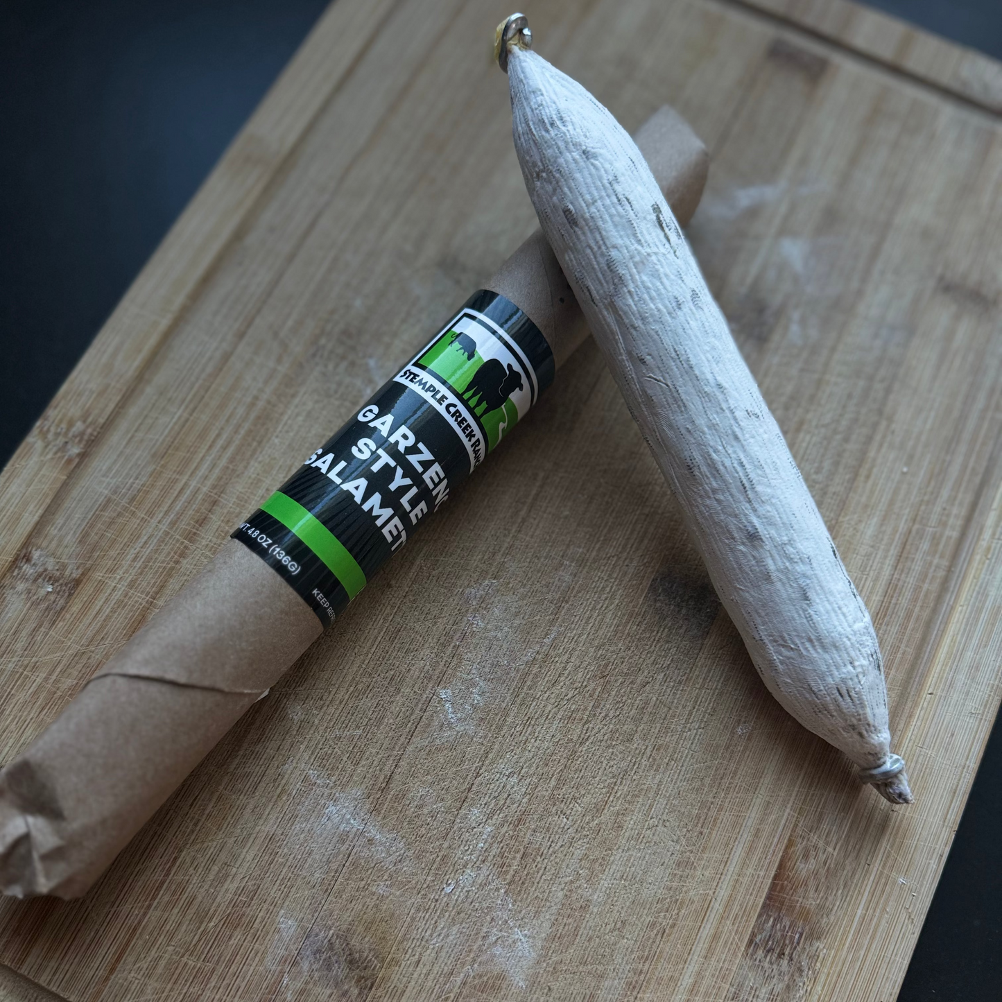 Cured meat with a label on a wooden cutting board